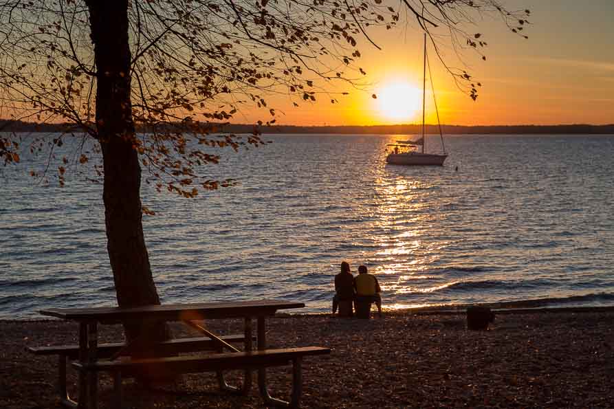Image of boat on the lake at sunset.